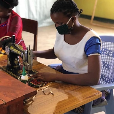 Bandari womens project participant sewing face masks at sewing machine