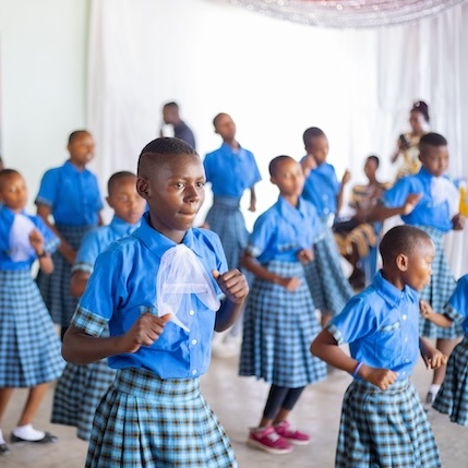 Bandari project staff member holding baby calf
